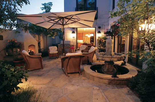 The soothing sounds of water and the scents of summer flowers make this outdoor living space, landscaped by Lifescape Associates, Inc., a room with a natural view.